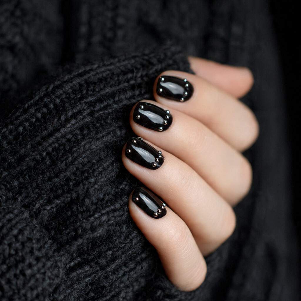 black nails with minimal stud details add