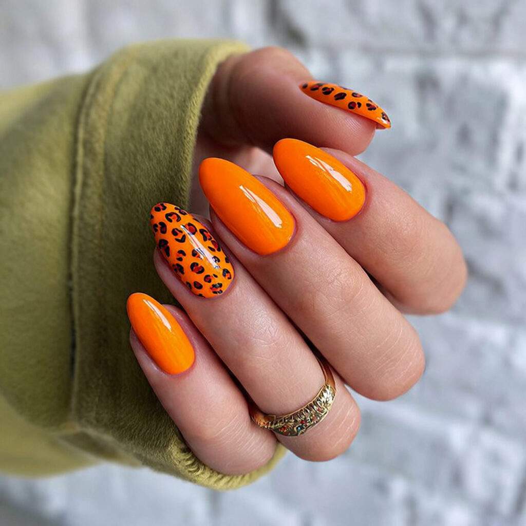 bold orange nails are a vibrant leo 1