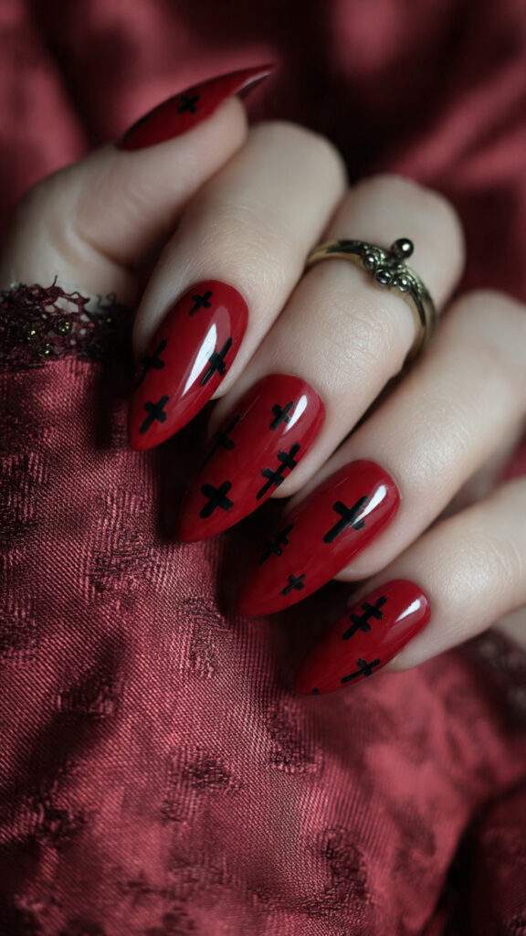 crimson almond nails with black crosses pin