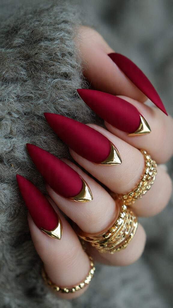 crimson nails with gold dagger accents stiletto