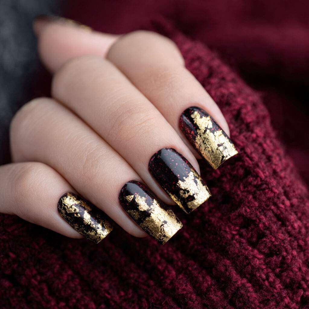 gold foil nails over a black or