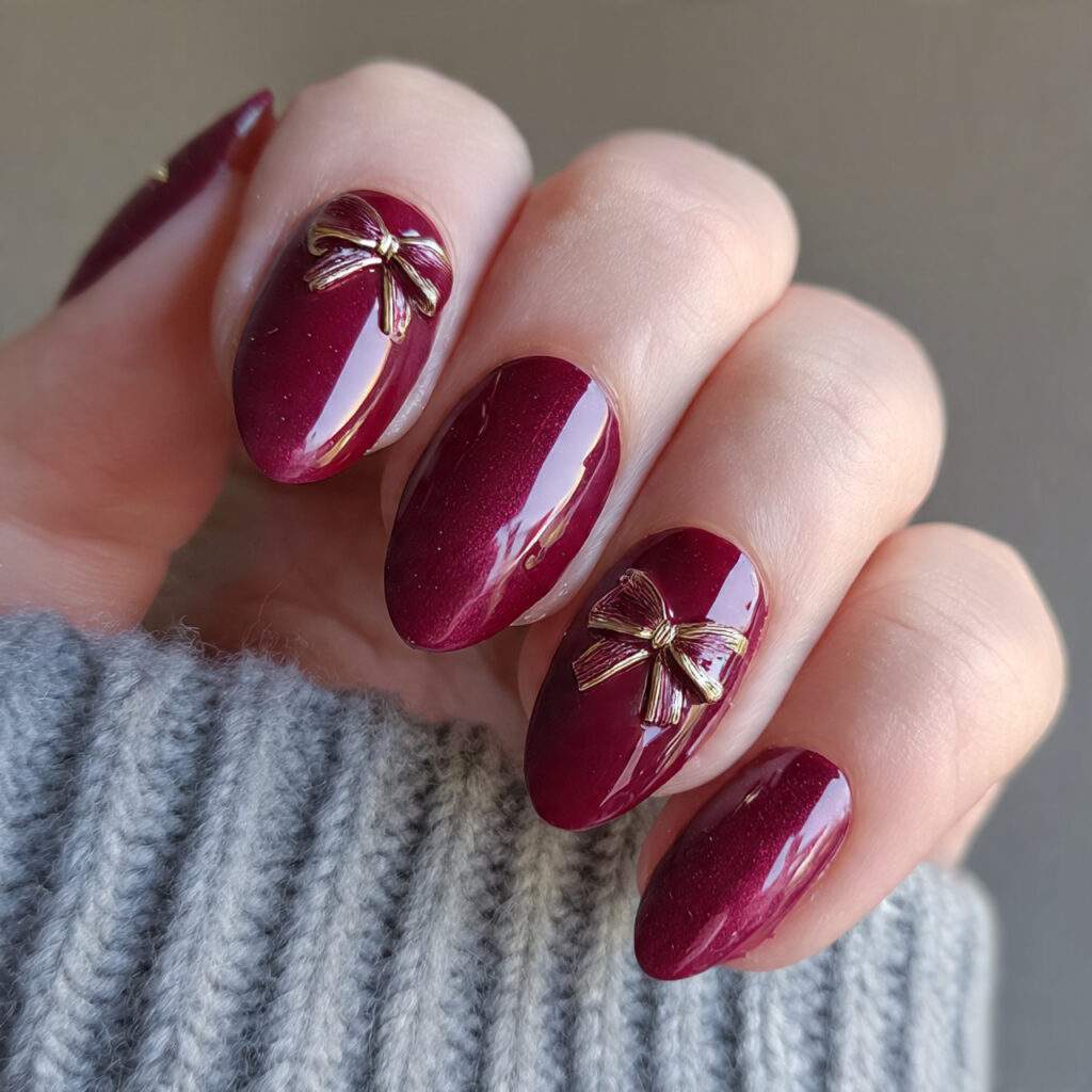holiday bow glam burgundy nails feel playful
