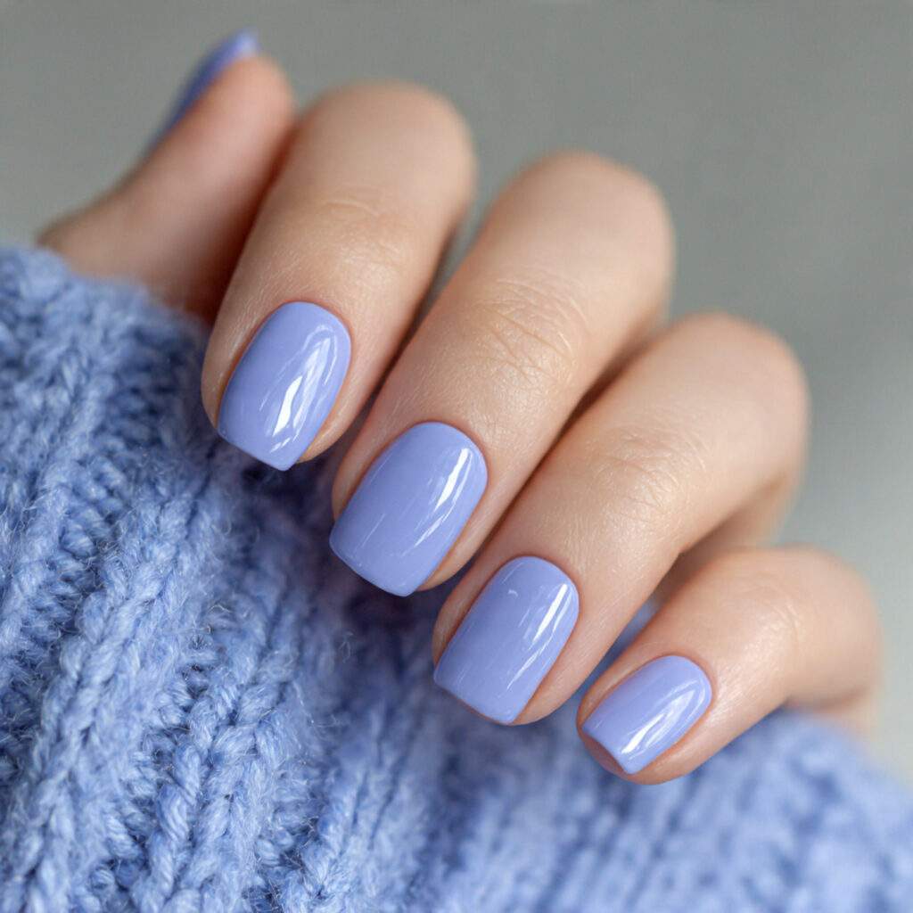 short nails painted in soft periwinkle blue