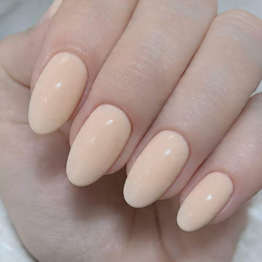 warm creamy almond toned nails natural looking glossy finish