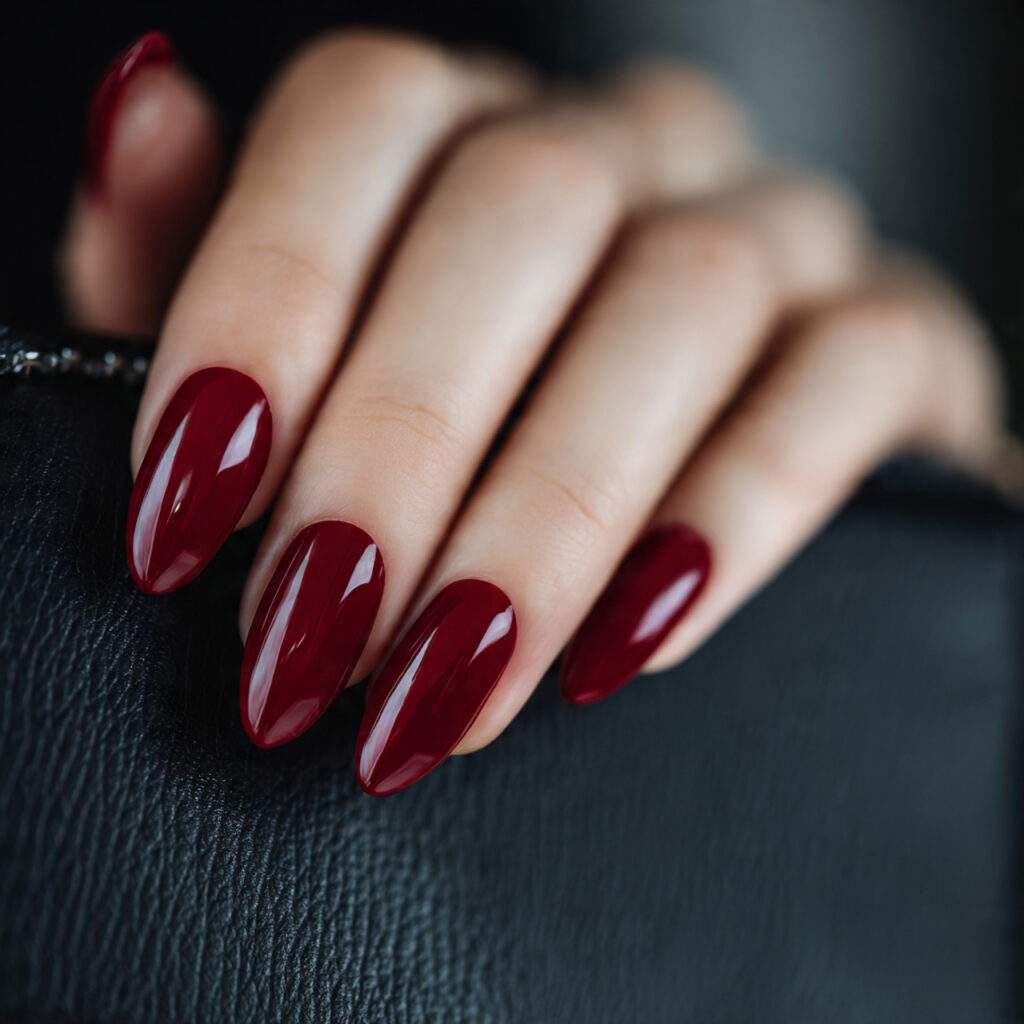 medium almond shaped nails painted in deep true re